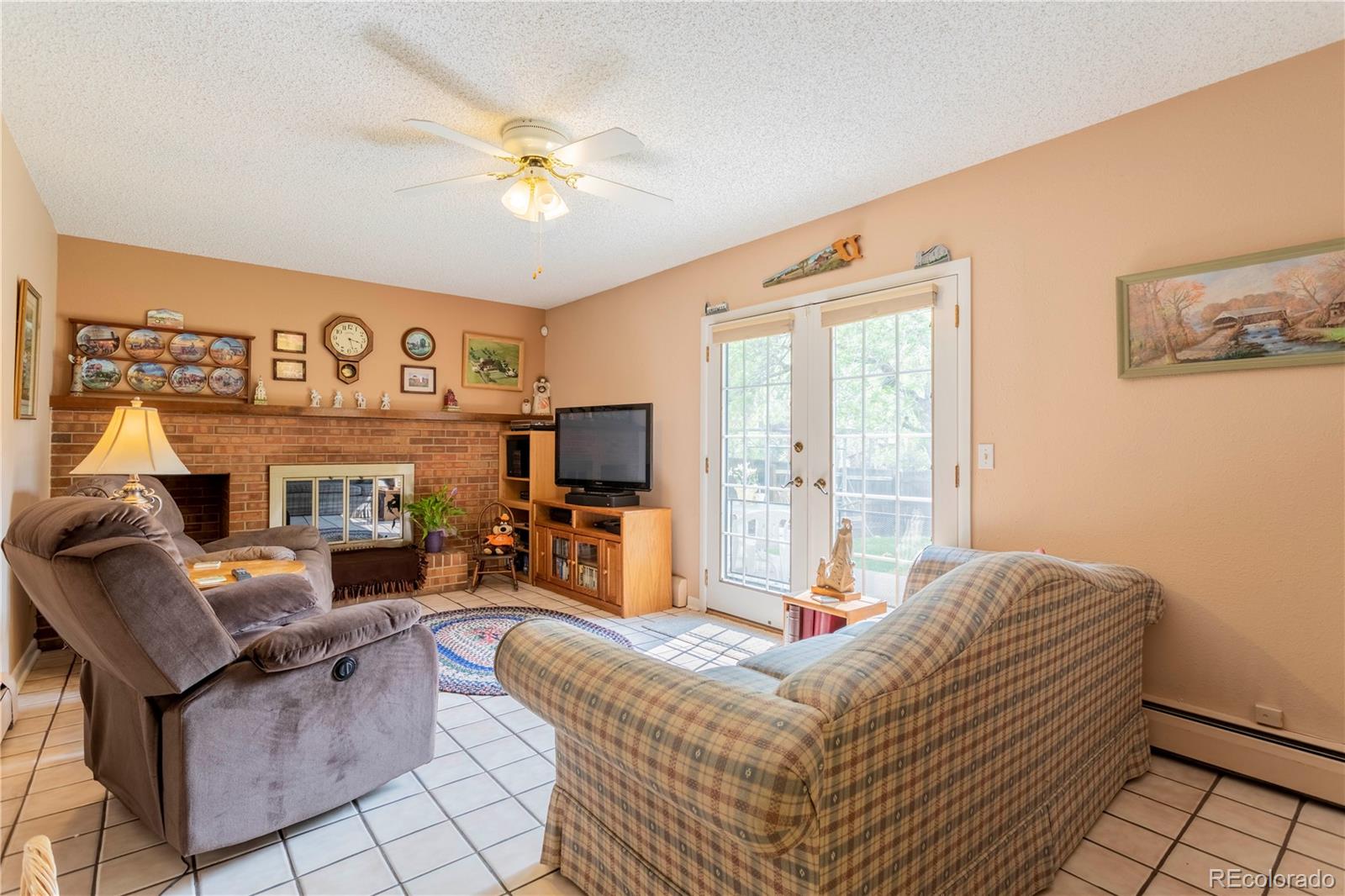 6001 Welch Street Arvada, CO 80004 - Photo 11 of 32 a living room with furniture and a flat screen tv