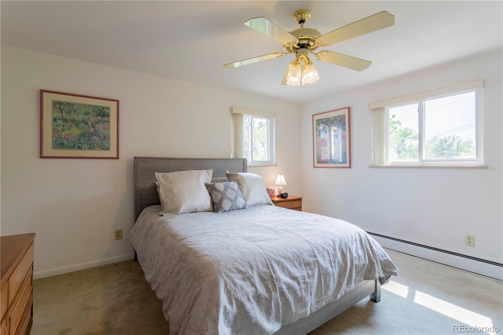 6001 Welch Street Arvada, CO 80004 - Photo 14 of 32 a bedroom with a bed and a chandelier