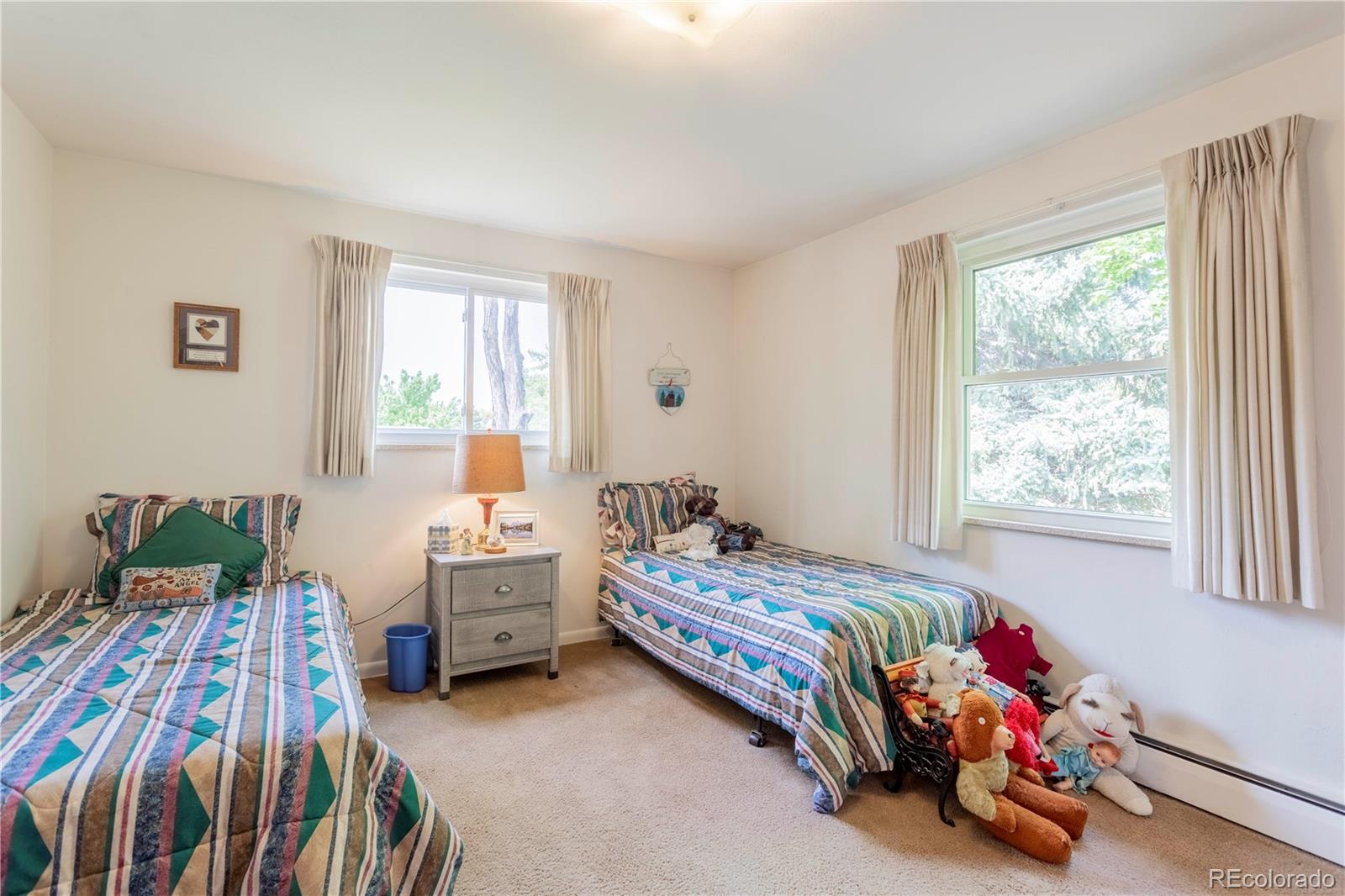 6001 Welch Street Arvada, CO 80004 - Photo 17 of 32 a bedroom with a bed and a window