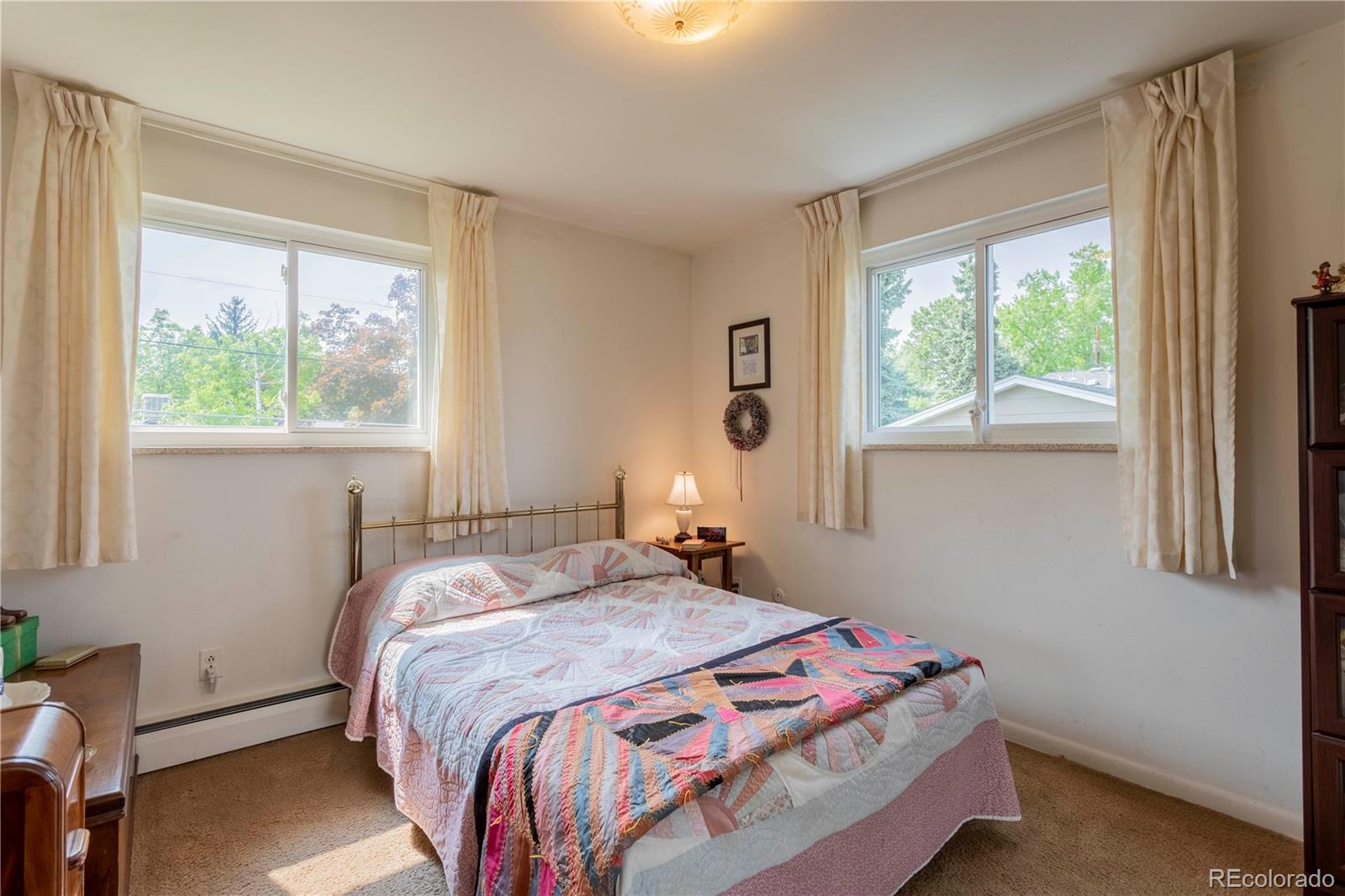 6001 Welch Street Arvada, CO 80004 - Photo 19 of 32 a bedroom with a bed and a window