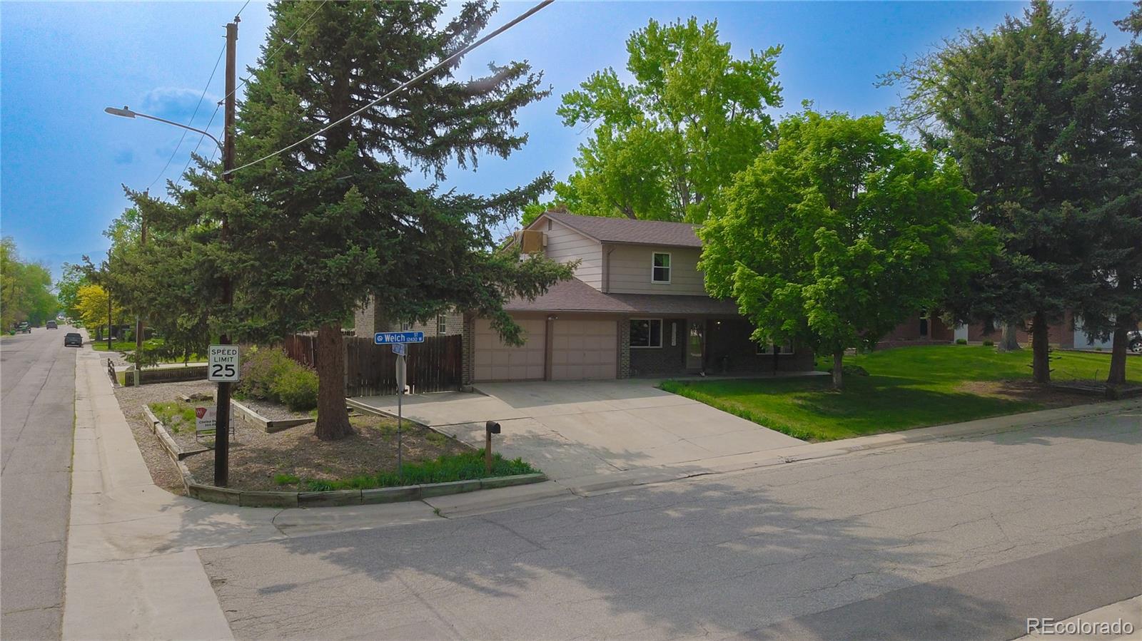6001 Welch Street Arvada, CO 80004 - Photo 30 of 32 a front view of a house with garden