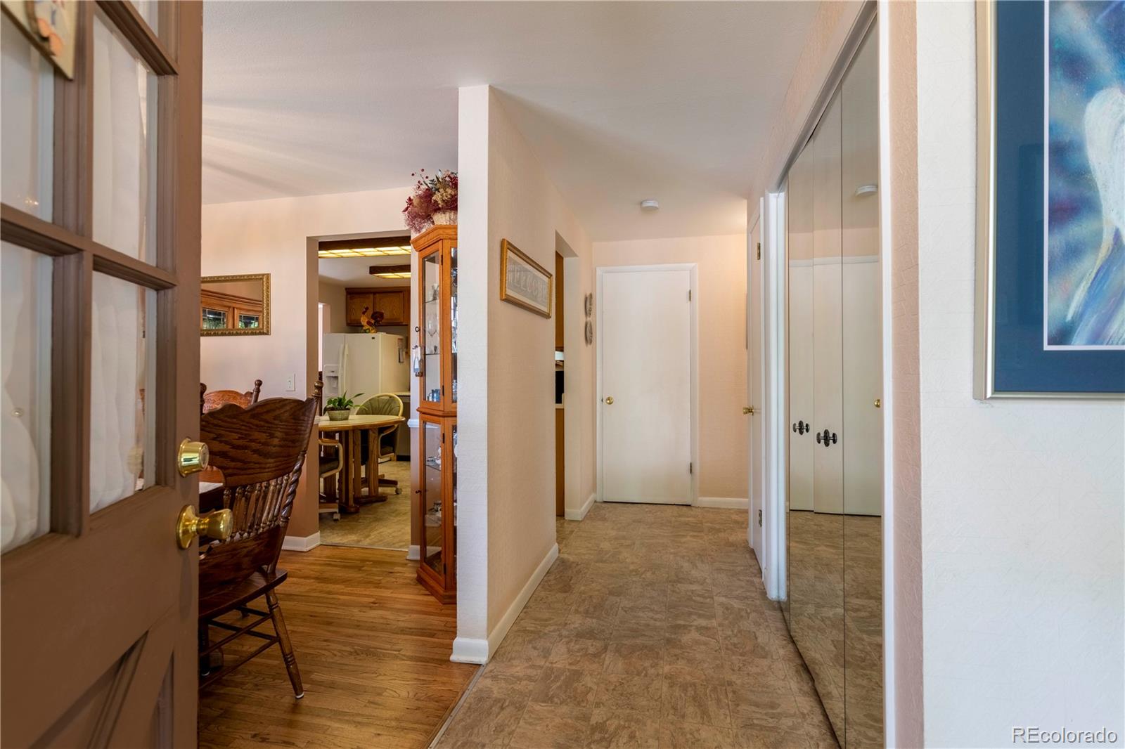 6001 Welch Street Arvada, CO 80004 - Photo 5 of 32 a view of a hallway with dining area and glass door