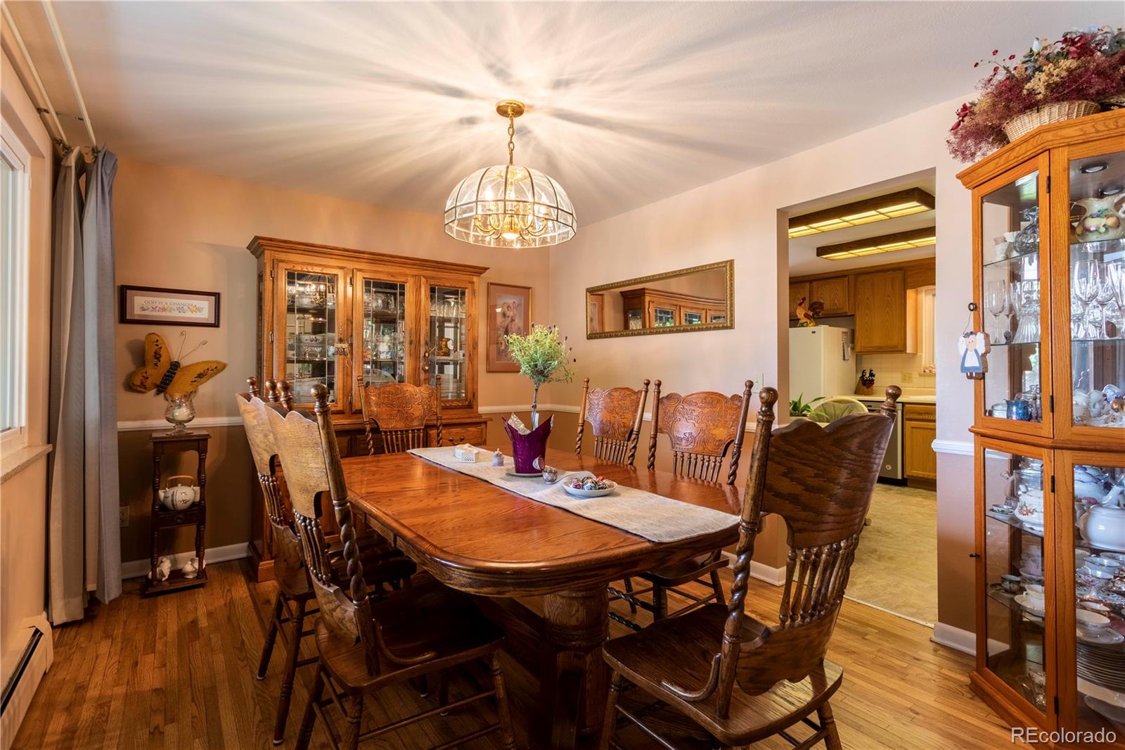 6001 Welch Street Arvada, CO 80004 - Photo 6 of 32 a view of a dining room with furniture window and wooden floor