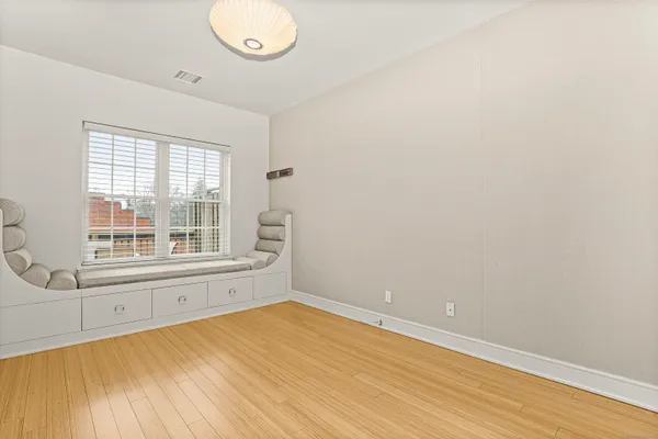 a bedroom with a bed and a large window