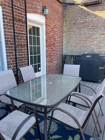 a balcony view with a seating space