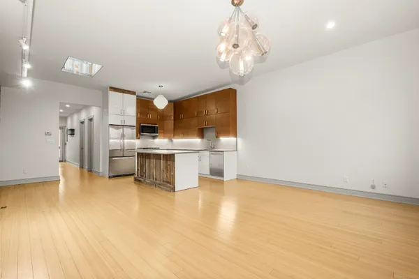 a view of kitchen with refrigerator and microwave
