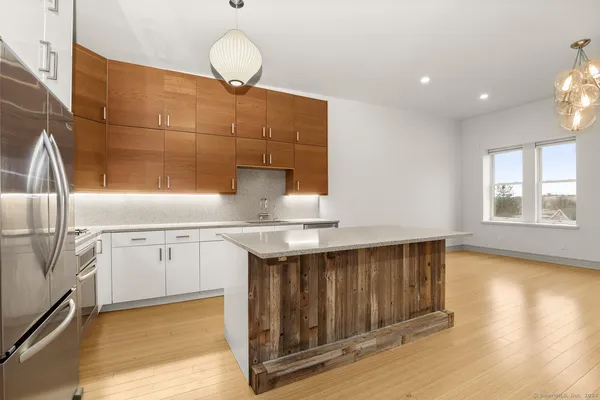 a kitchen with stainless steel appliances granite countertop a sink a stove and a oven