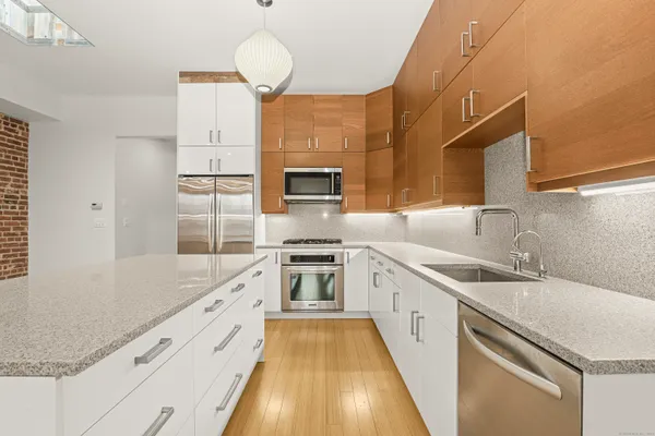 a kitchen with a sink stove and refrigerator