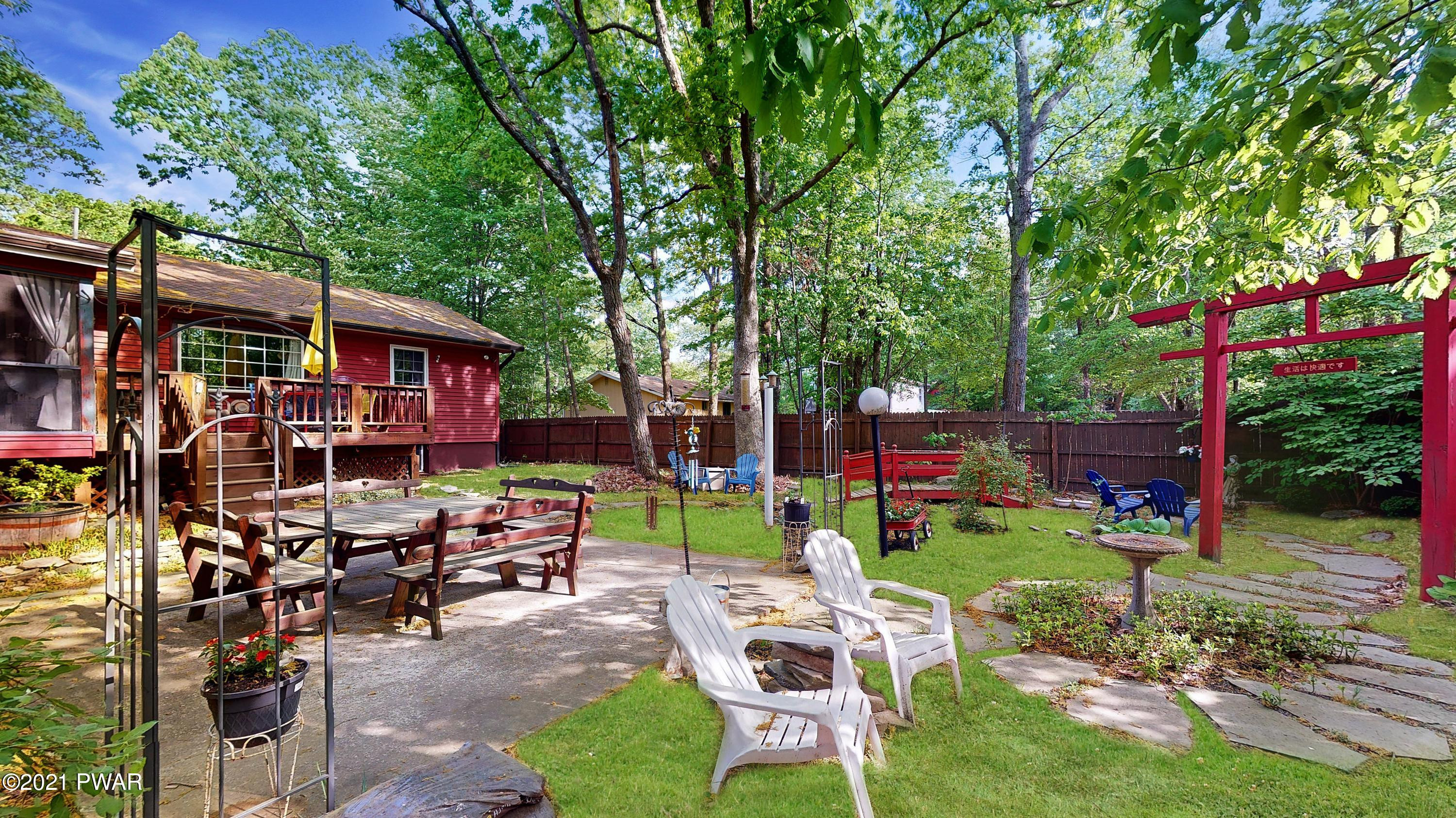 157 Roundhill Road Dingmans Ferry, PA 18328 - Photo 21 of 48 a view of a chairs and table in backyard of the house