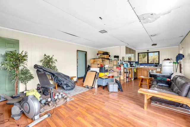 a living room filled with furniture and wooden floor