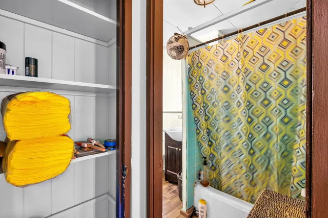 a view of walk in closet and living room