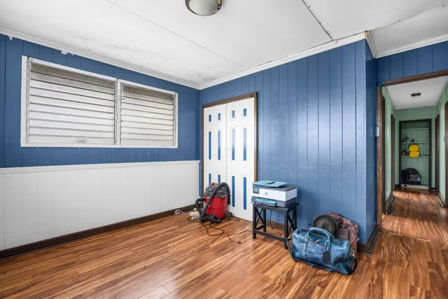 a view of a livingroom with wooden floor and furniture