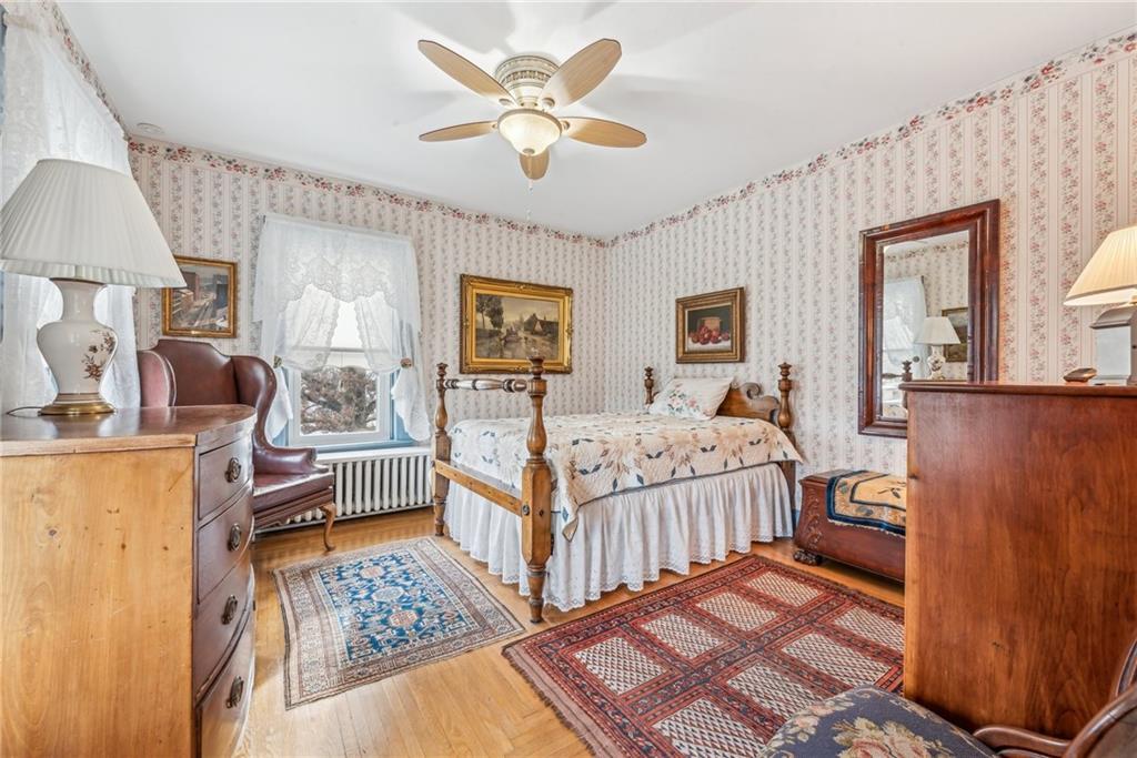 737 Buttermore Road Ruffs Dale, PA 15679 - Photo 23 of 39 a bedroom with a bed and a chandelier