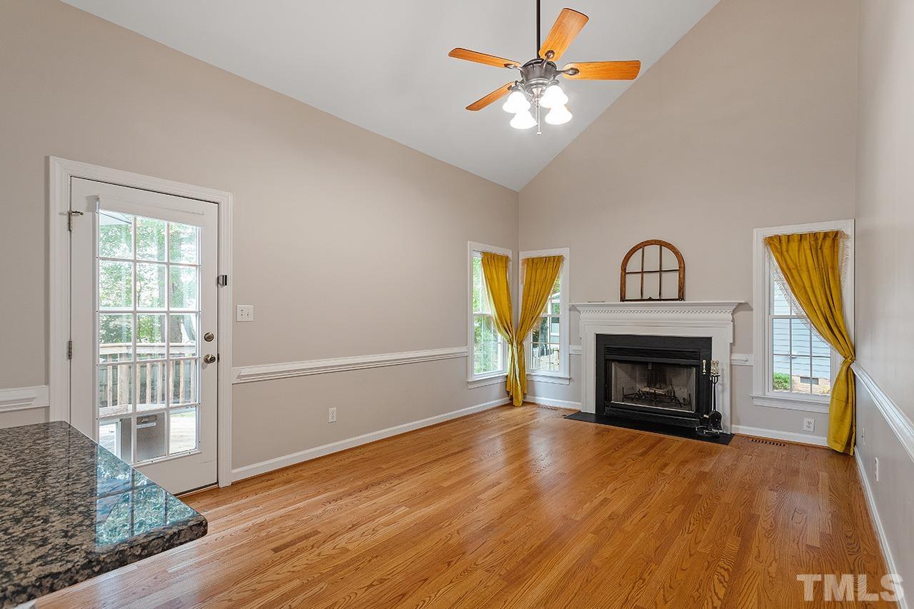 403 Danton Drive Cary, NC 27518 - Photo 12 of 38 wooden floor fireplace and windows in an empty room