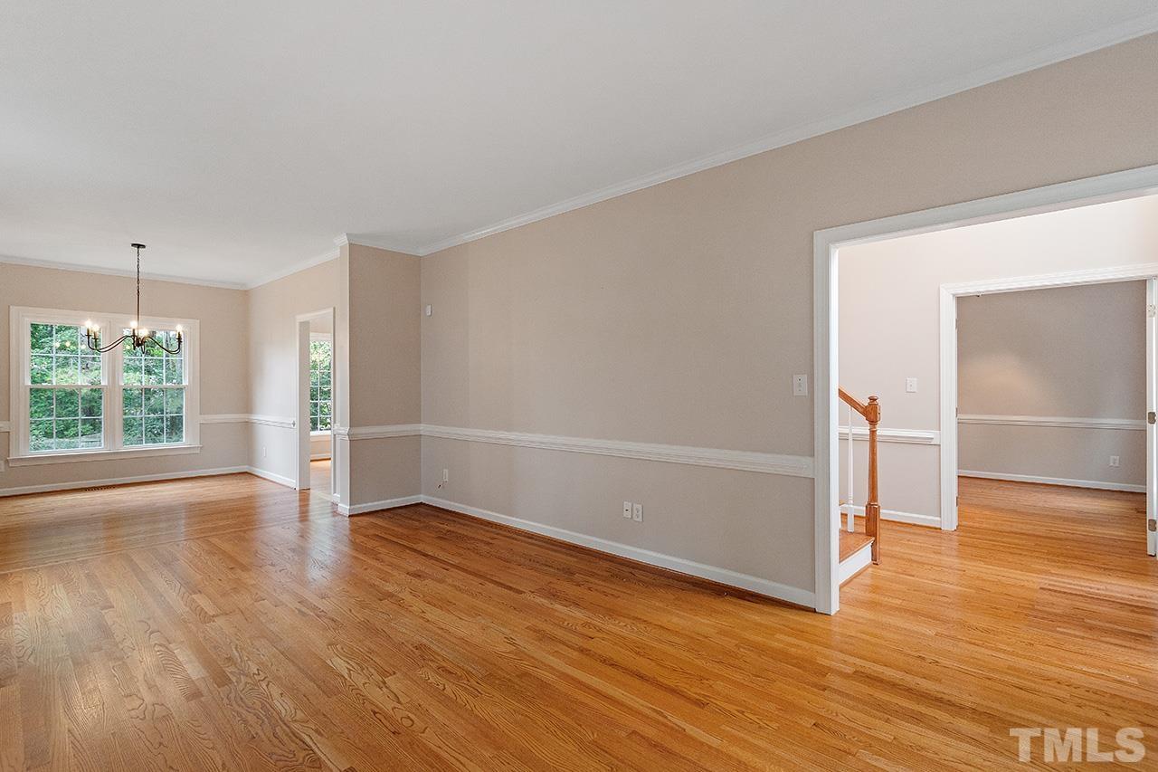 403 Danton Drive Cary, NC 27518 - Photo 14 of 38 an empty room with wooden floor and windows