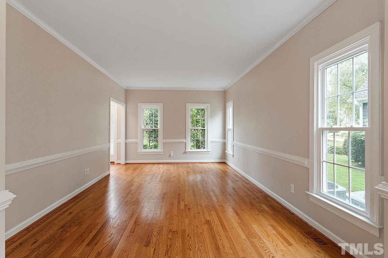 403 Danton Drive Cary, NC 27518 - Photo 15 of 38 a view of an empty room with wooden floor and a window