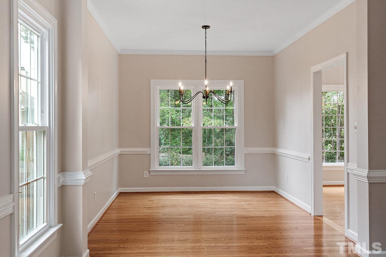 403 Danton Drive Cary, NC 27518 - Photo 16 of 38 a view of an empty room with wooden floor and a window