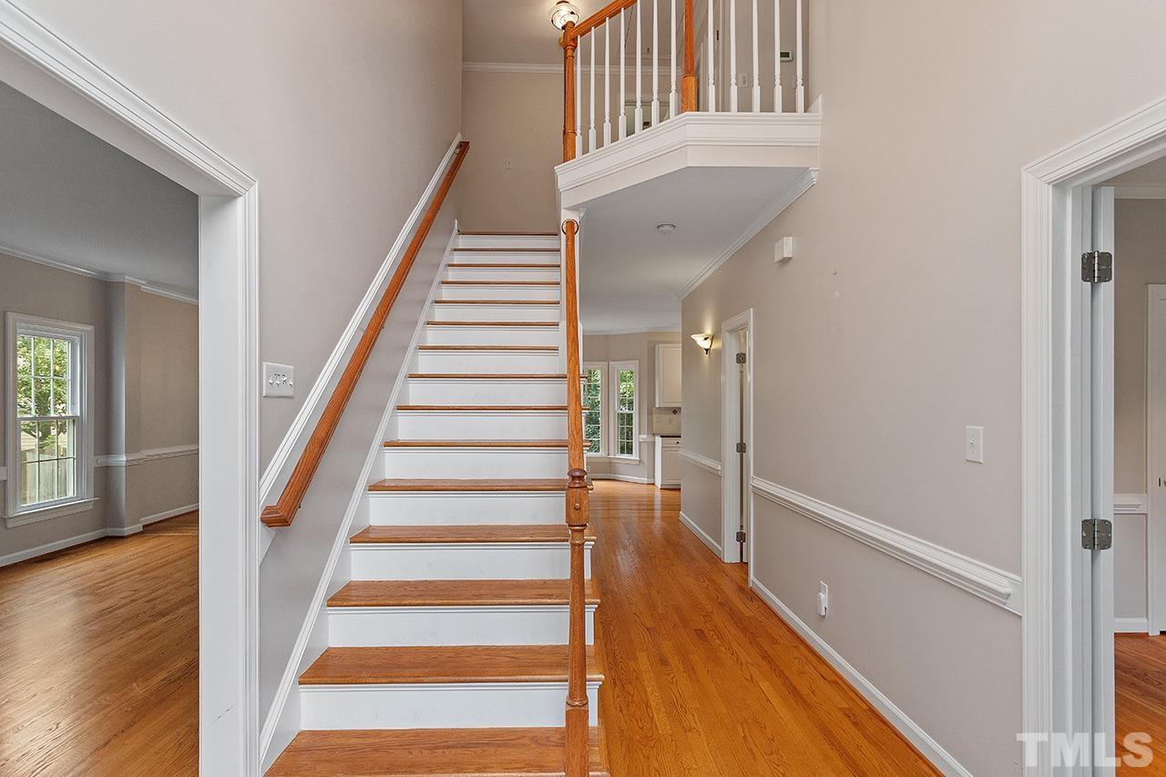 403 Danton Drive Cary, NC 27518 - Photo 18 of 38 a view of staircase with white walls and windows