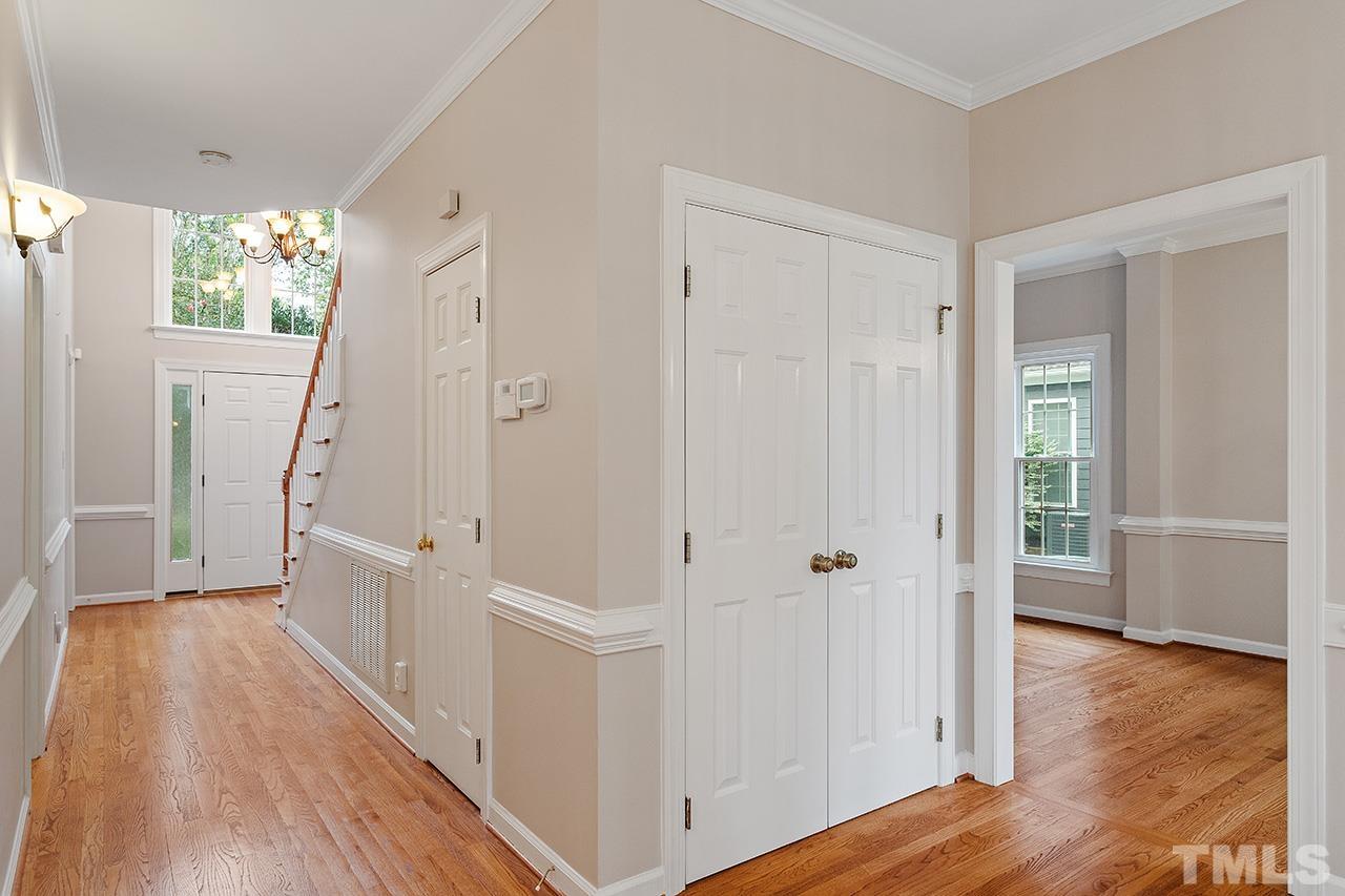 403 Danton Drive Cary, NC 27518 - Photo 19 of 38 a view of a hallway with wooden floor and staircase