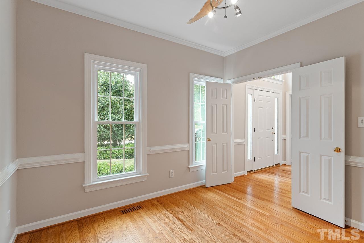 403 Danton Drive Cary, NC 27518 - Photo 21 of 38 a view of empty room with wooden floor and fan