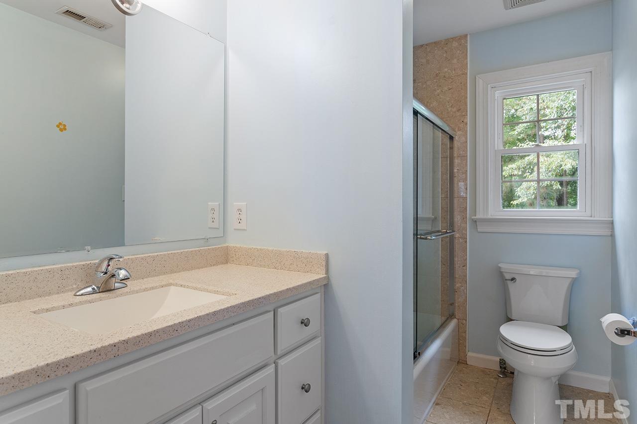 403 Danton Drive Cary, NC 27518 - Photo 29 of 38 a bathroom with a sink toilet and a window
