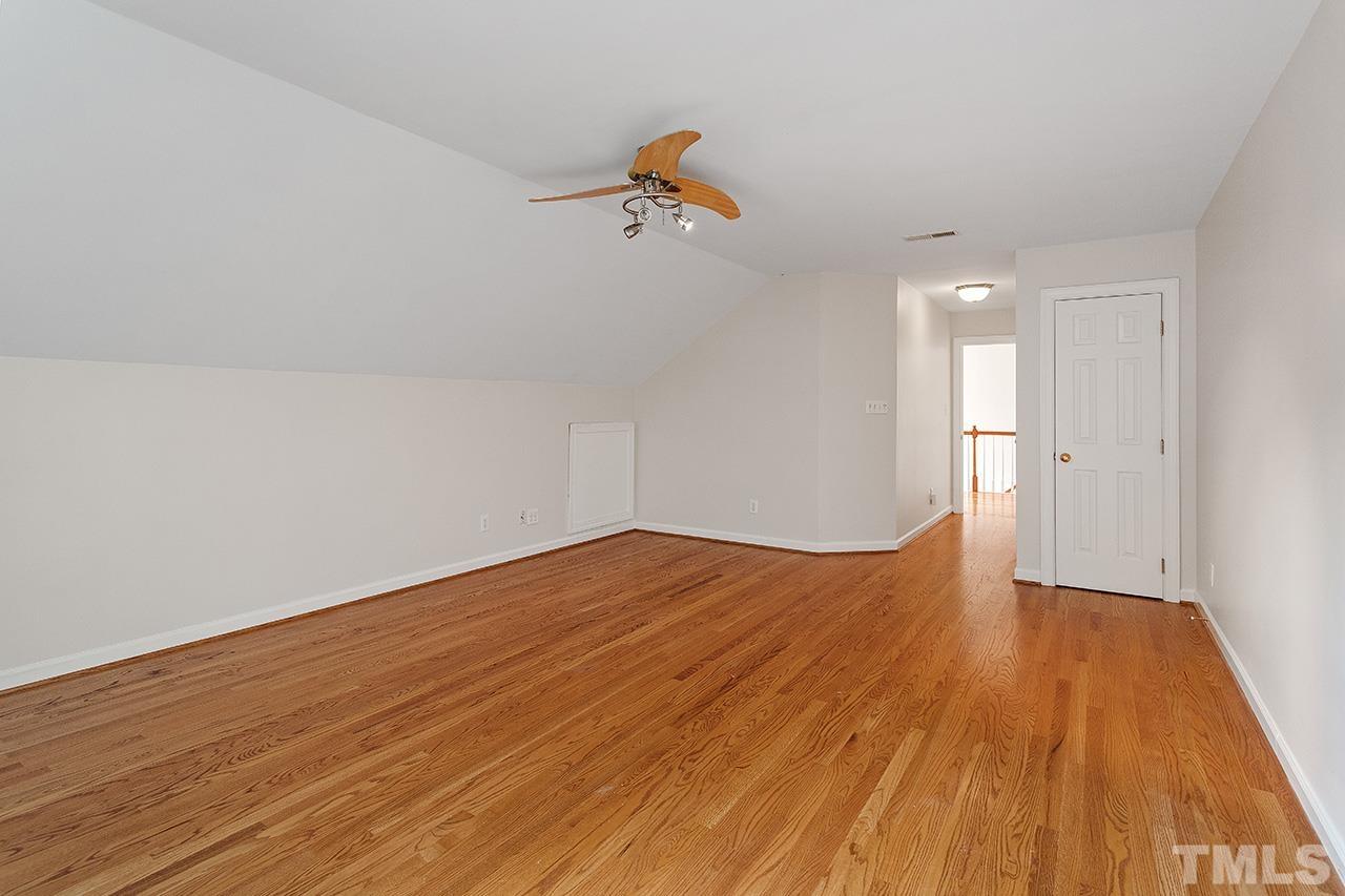 403 Danton Drive Cary, NC 27518 - Photo 30 of 38 a view of empty room with wooden floor and ceiling fan