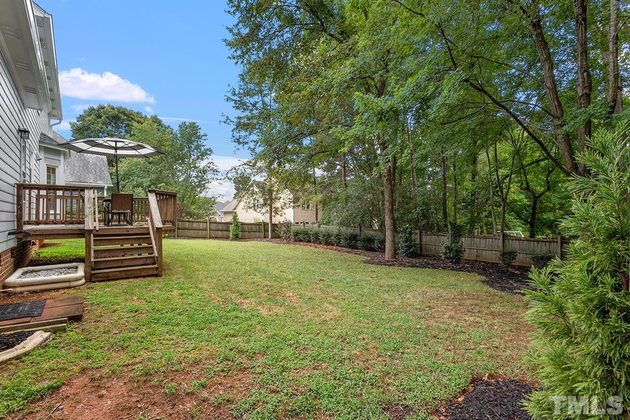 403 Danton Drive Cary, NC 27518 - Photo 33 of 38 a view of a backyard with wooden fence and a bench