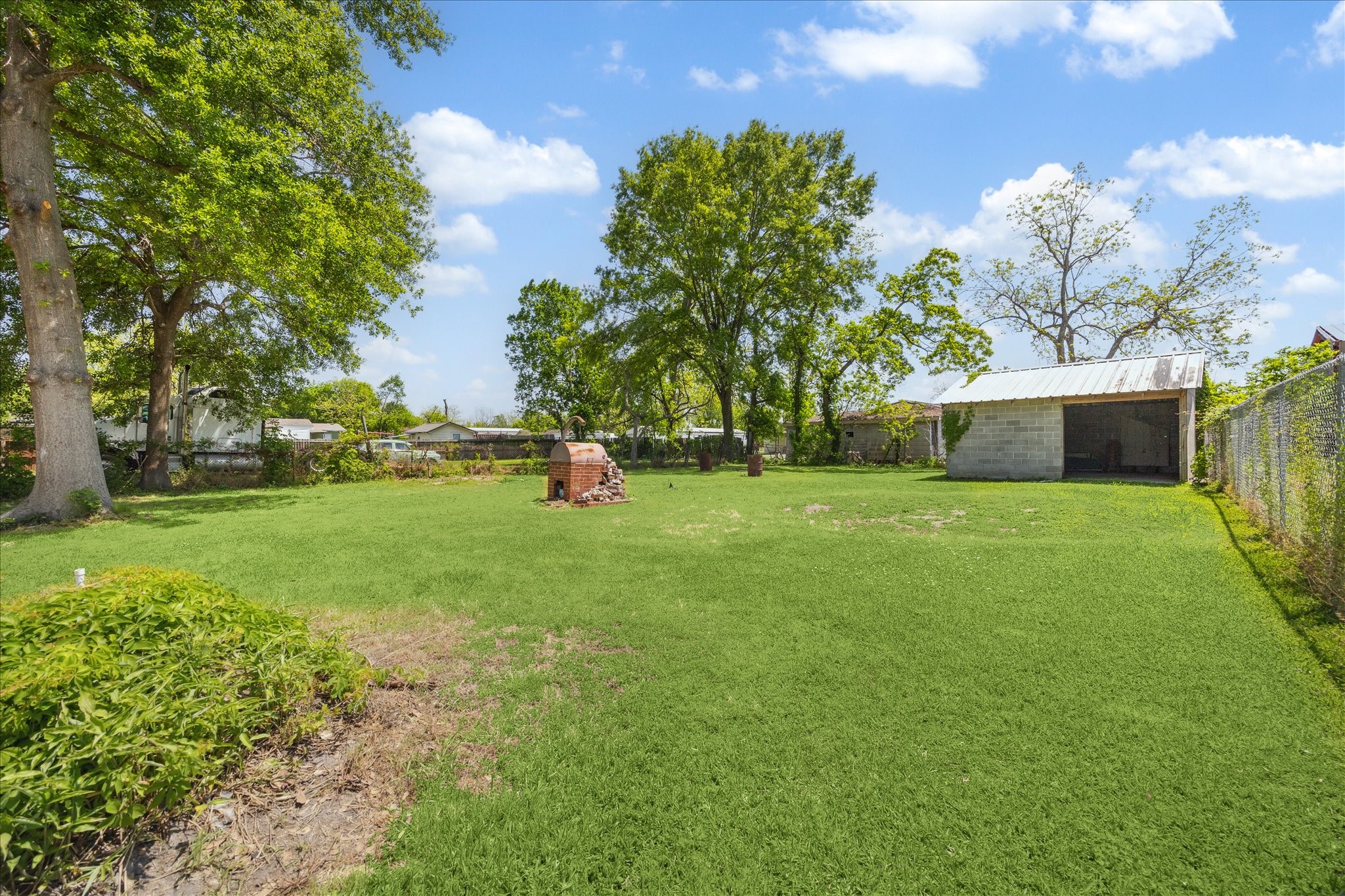a view of a backyard with a garden and entertaining space