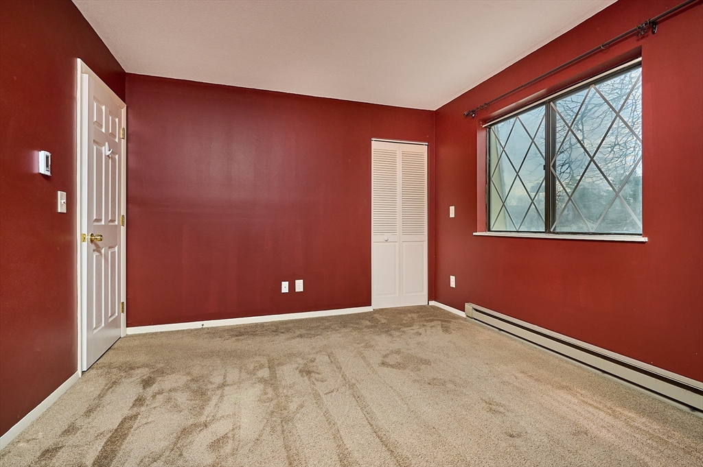 170 East Hadley Road, Unit 124 Amherst, MA 01002 - Photo 11 of 20 an empty room with windows
