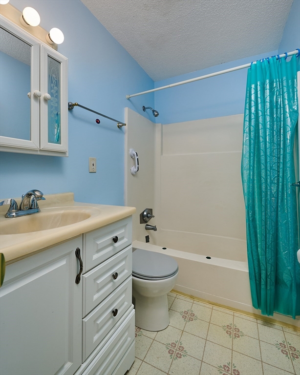 170 East Hadley Road, Unit 124 Amherst, MA 01002 - Photo 12 of 20 a bathroom with a sink a toilet and shower