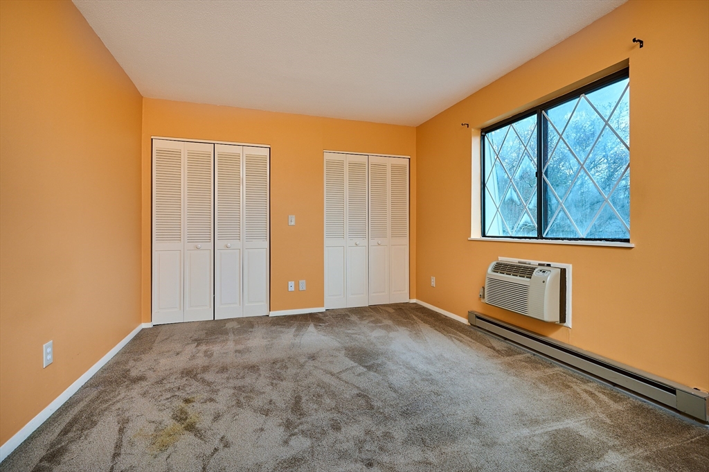 170 East Hadley Road, Unit 124 Amherst, MA 01002 - Photo 8 of 20 an empty room with windows