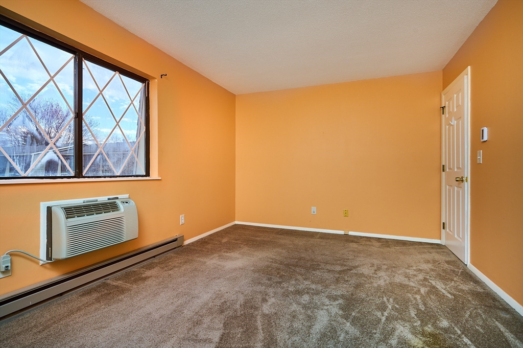 170 East Hadley Road, Unit 124 Amherst, MA 01002 - Photo 9 of 20 an empty room with windows