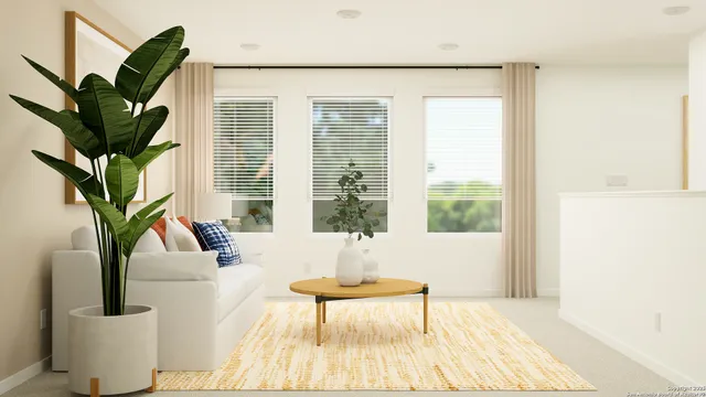 a living room with furniture and a potted plant