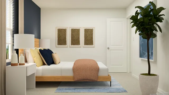 a bedroom with a bed and a potted plant