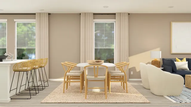 a view of a dining room with furniture and a window