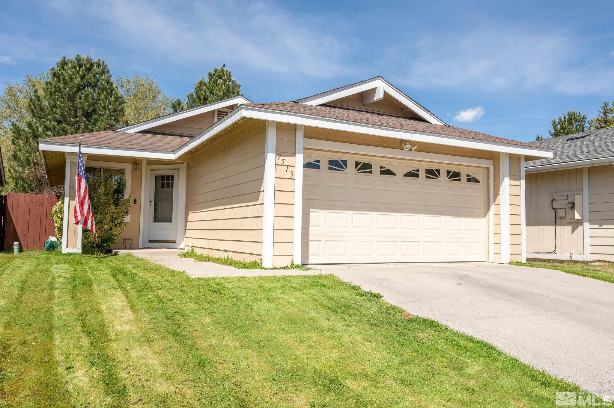 7513 Devonshire Lane Reno, NV 89511 - Photo 1 of 16 a front view of a house with a yard and garage