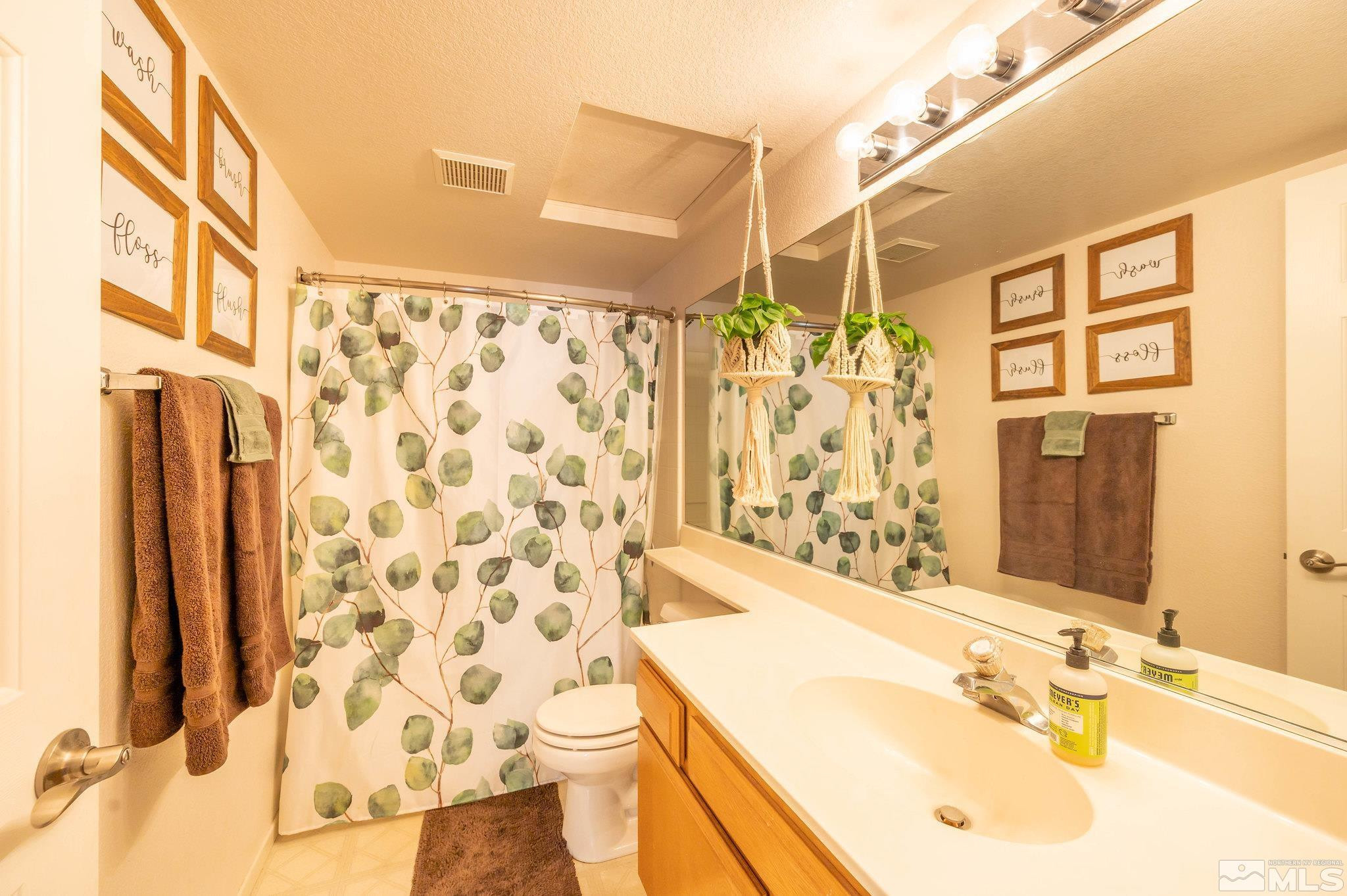 7513 Devonshire Lane Reno, NV 89511 - Photo 13 of 16 a bathroom with a sink mirror and a shower