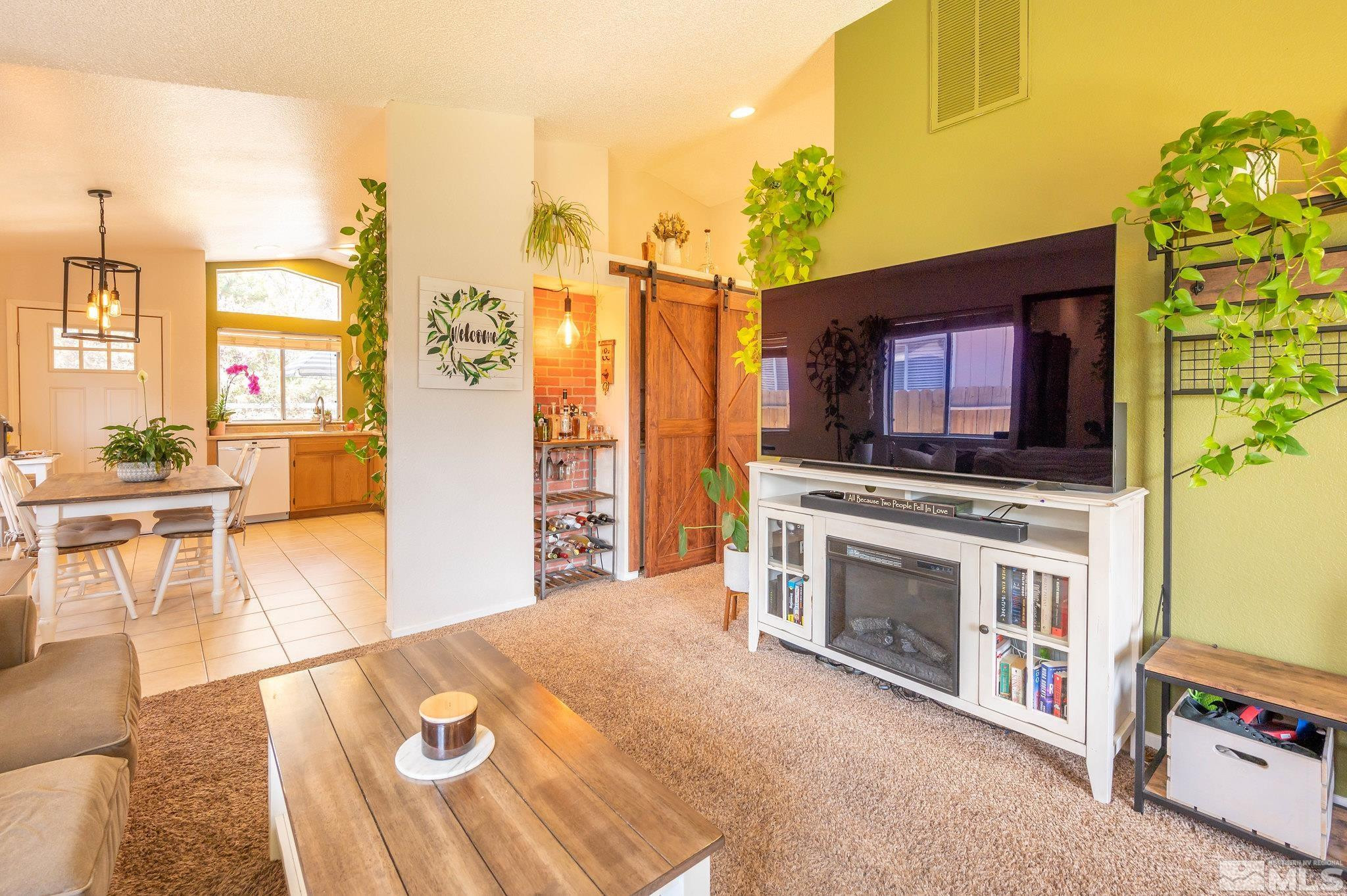 7513 Devonshire Lane Reno, NV 89511 - Photo 2 of 16 a kitchen with stainless steel appliances a stove a sink and a microwave