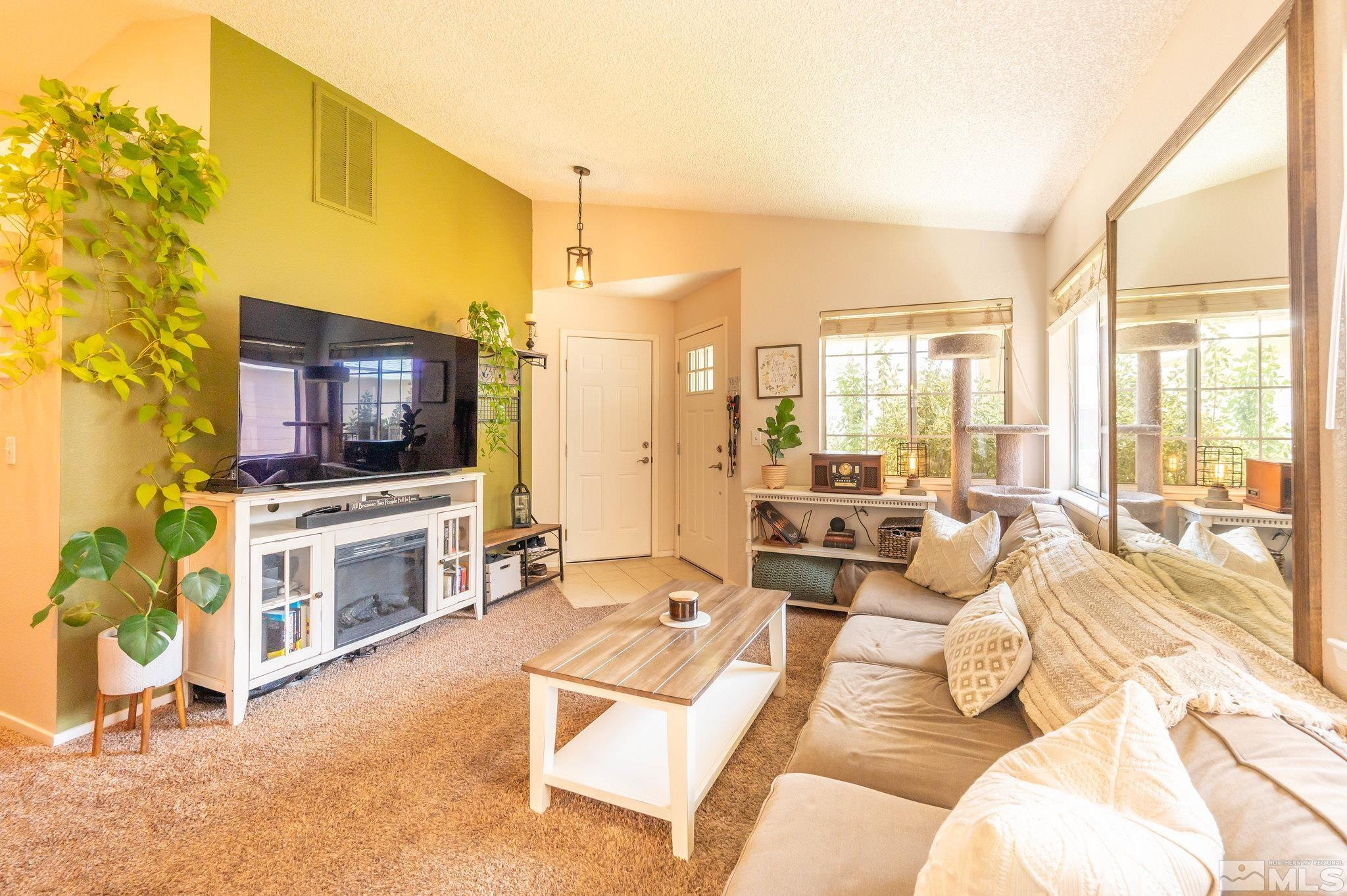 7513 Devonshire Lane Reno, NV 89511 - Photo 4 of 16 a living room with furniture and a flat screen tv