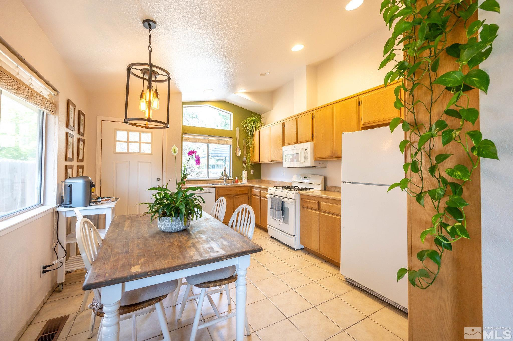 7513 Devonshire Lane Reno, NV 89511 - Photo 5 of 16 a kitchen with stainless steel appliances granite countertop a refrigerator a sink a stove and white cabinets