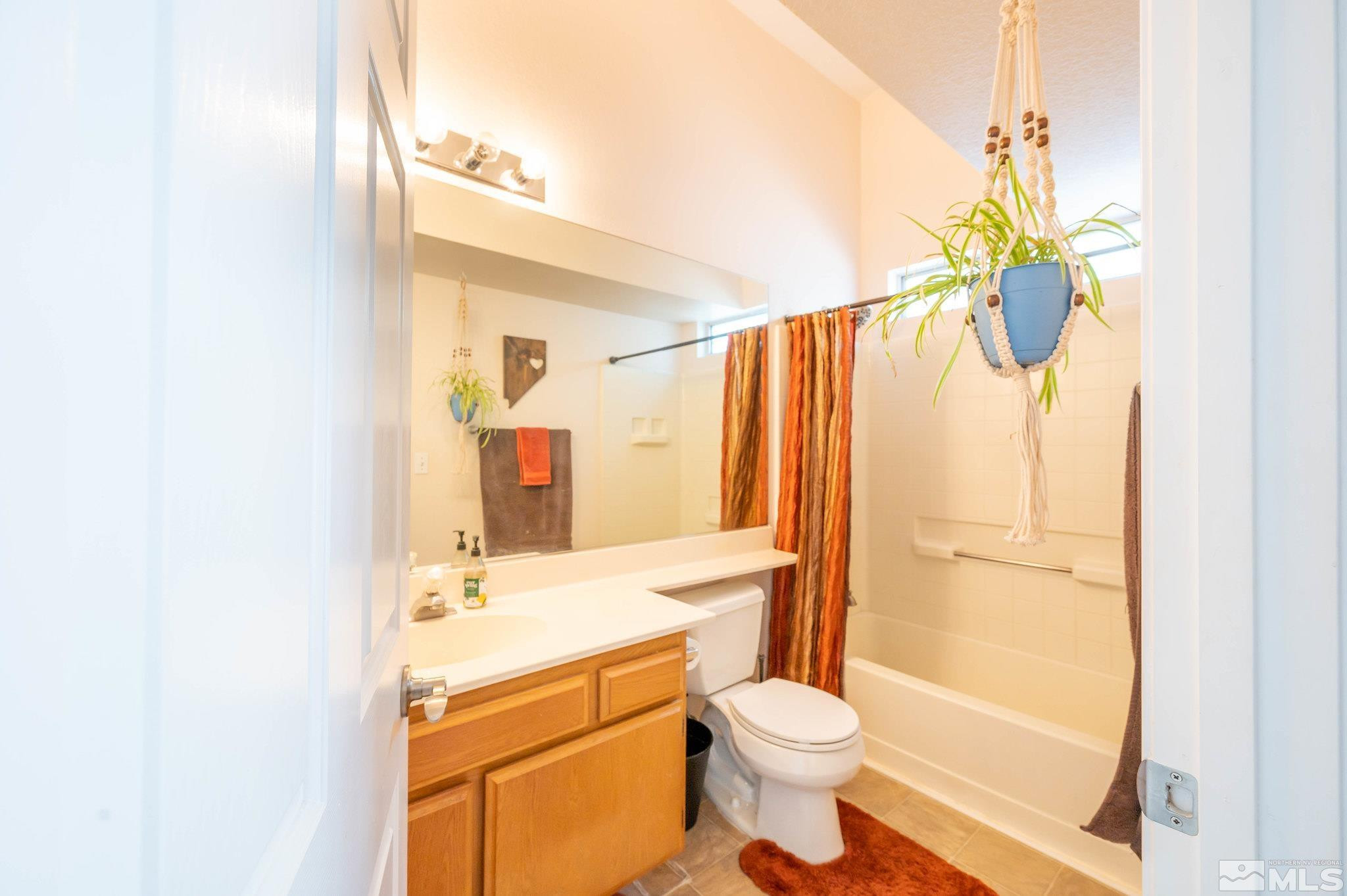 7513 Devonshire Lane Reno, NV 89511 - Photo 8 of 16 a bathroom with a sink a toilet and shower