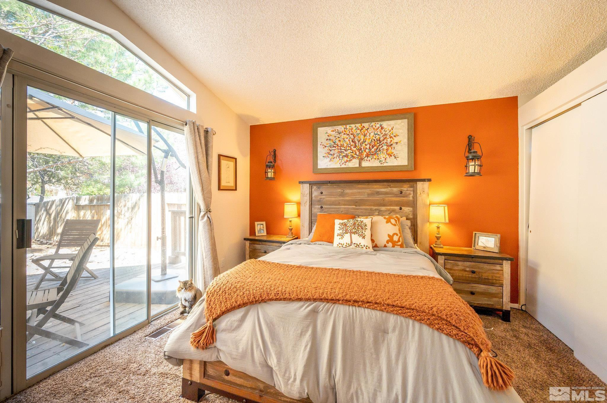 7513 Devonshire Lane Reno, NV 89511 - Photo 9 of 16 a bedroom with a bed and a large window with outer view