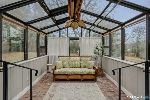 a balcony with furniture and a potted plant