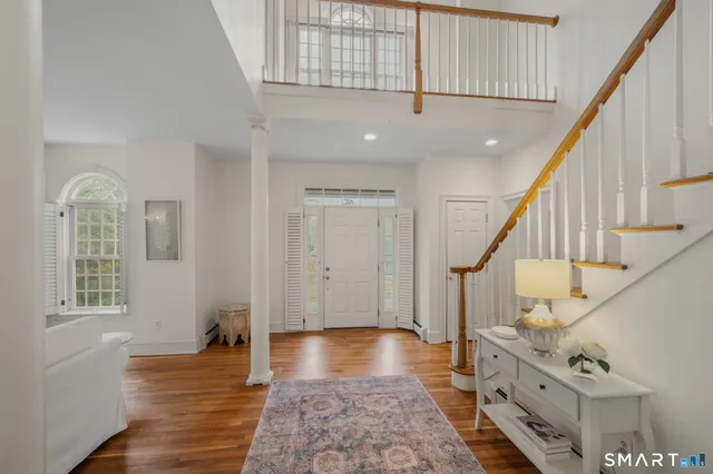 a view of an entryway with wooden floor and stairs