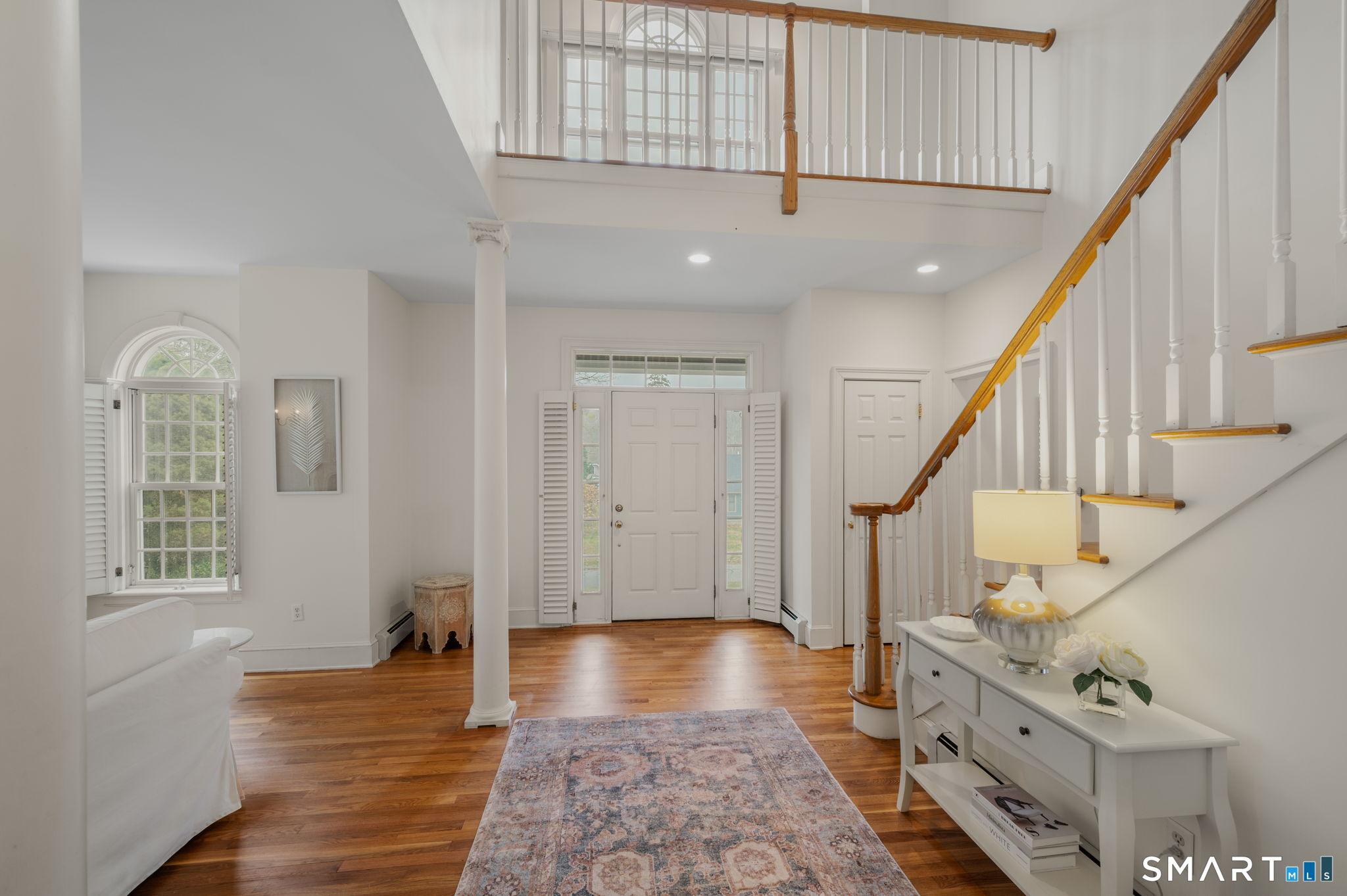 14 Riverside Drive Waterford, CT 06385 - Photo 2 of 40 a view of an entryway with wooden floor and stairs