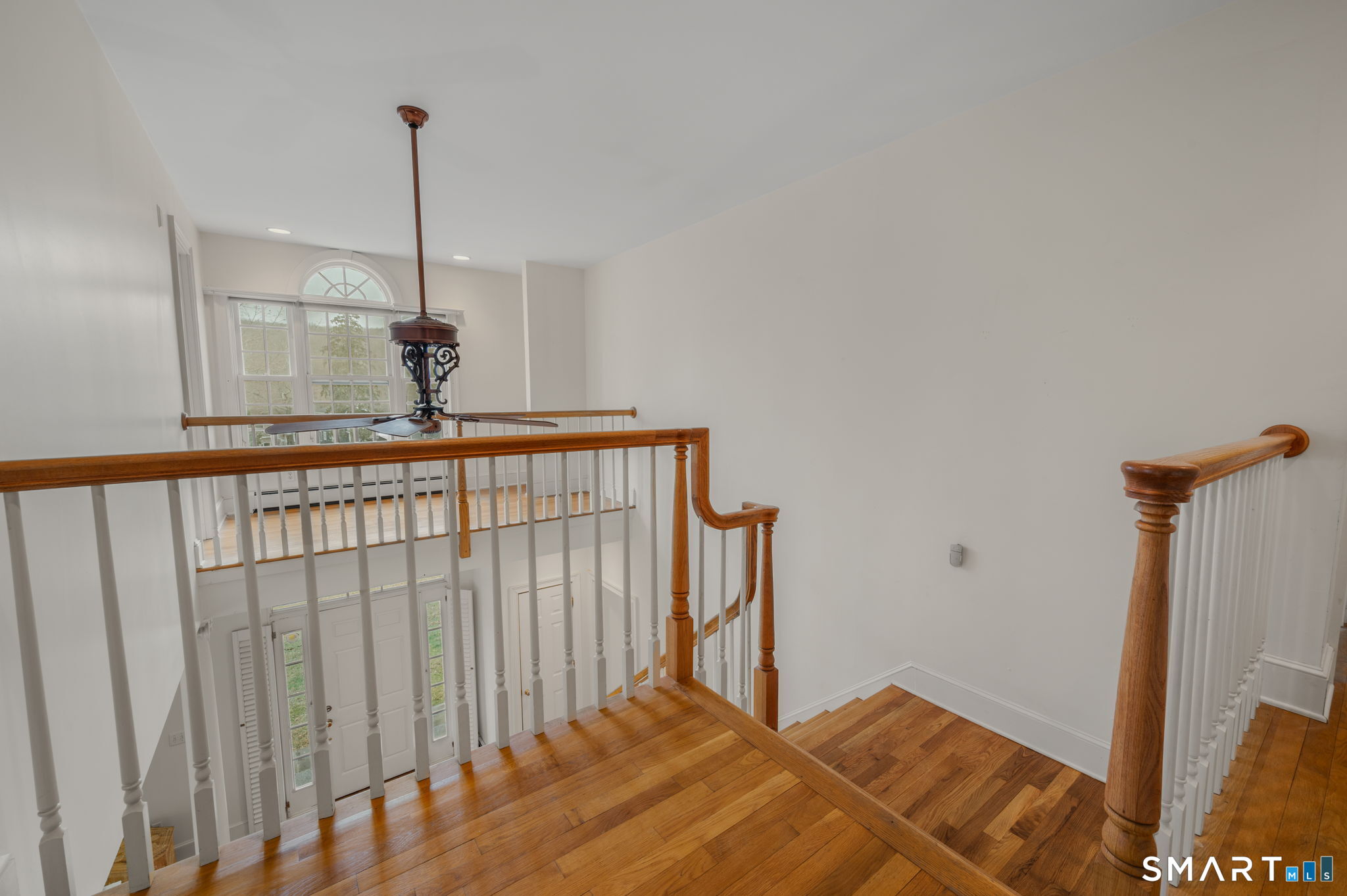 14 Riverside Drive Waterford, CT 06385 - Photo 24 of 40 a bedroom with a bed and a chandelier