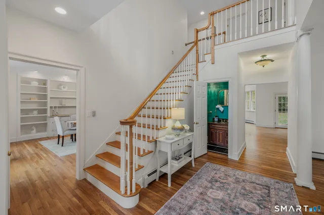 a view of entryway with wooden floor and stairs