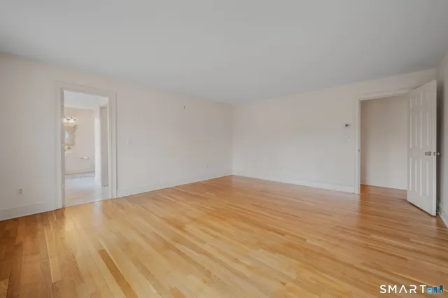 a view of an empty room and wooden floor