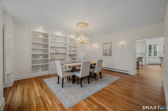 a view of a dining room with furniture and wooden floor