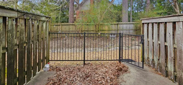 a view of a backyard with a fence